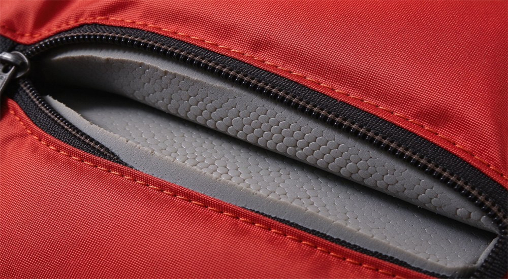 Macro close-up of NBR PVC closed-cell foam cross-section inside water rescue life jacket showing Cordura nylon outer shell precise stitching and zipper construction detail Macro close-up of NBR PVC closed-cell foam cross-section inside water rescue life jacket showing Cordura nylon outer shell precise stitching and zipper construction detail
