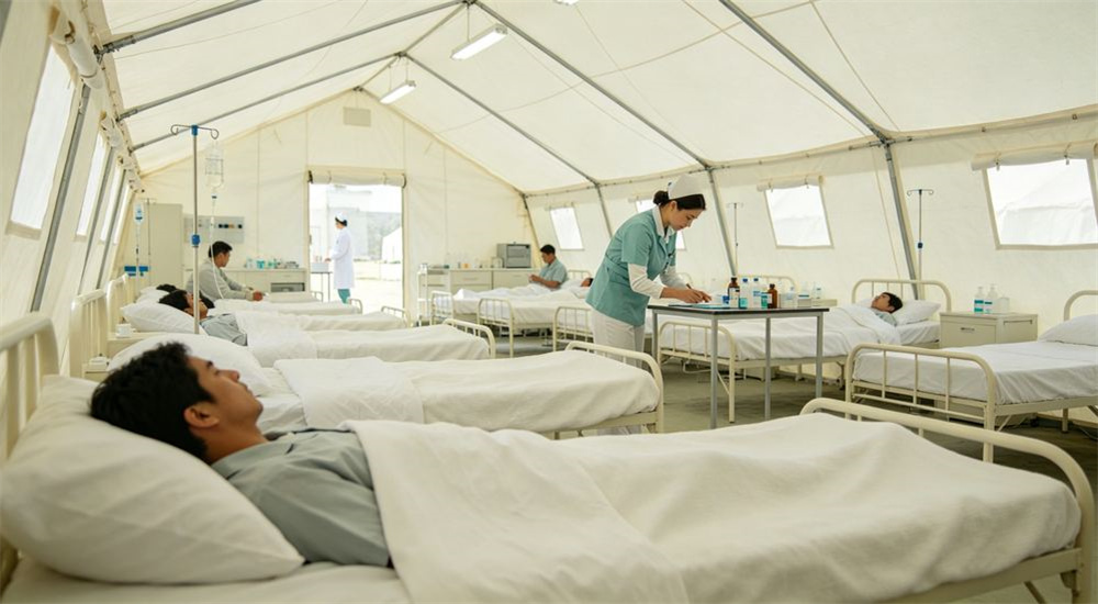 Inside a refugee camp shelter using emergency shelter bedding, durable relief linen on a simple bed, comfortable sleep space for a displaced family, professional textile photography with bright even lighting for humanitarian relief procurement buyers Inside a refugee camp shelter using emergency shelter bedding, durable relief linen on a simple bed, comfortable sleep space for a displaced family, professional textile photography with bright even lighting for humanitarian relief procurement buyers
