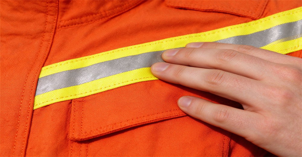 Durable woven orange rescue suit fabric with bright high visibility reflective strip stitched along the garment for improved visibility in low light Durable woven orange rescue suit fabric with bright high visibility reflective strip stitched along the garment for improved visibility in low light