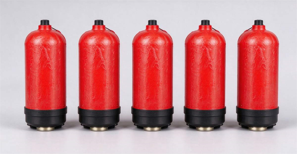 Five red buoy cartridges arranged in a row on light gray background showing rescue line projectile ammunition for line pneumatic line thrower Five red buoy cartridges arranged in a row on light gray background showing rescue line projectile ammunition for line pneumatic line thrower